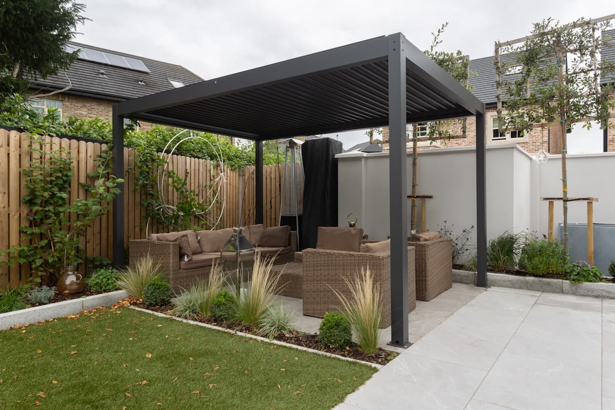 Modern louvered pergola over a residential backyard patio