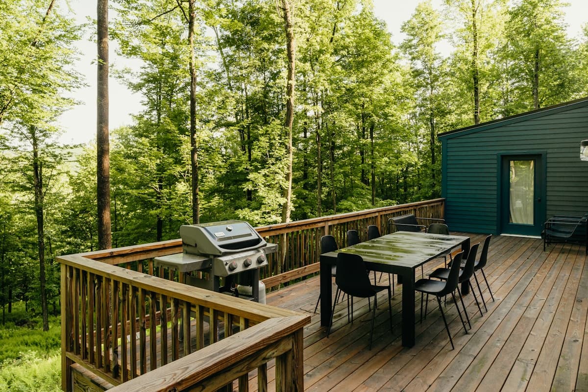 Freshly finished wood deck overlooking a forest backdrop
